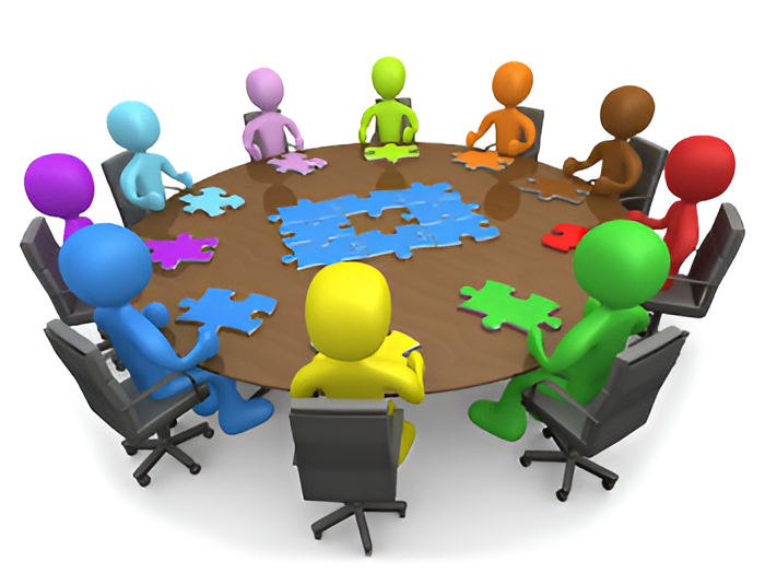 People around a table with puzzle pieces