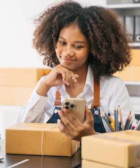 Small business owner with packages and a phone